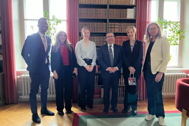 A photo of 6 people standing next to each other