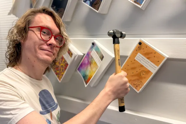 Joel nails dissortation to wall with hammer