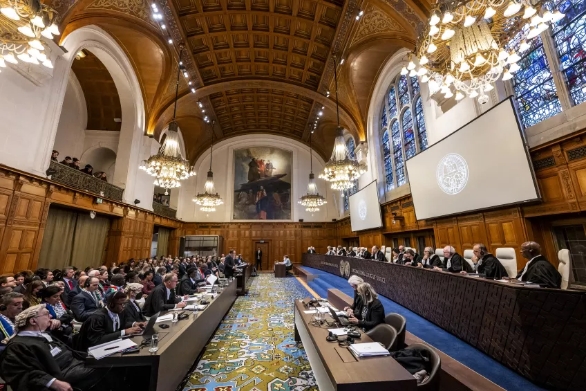 A photo of the court room at the International Court of Justice filled with people sitting behind desks.
