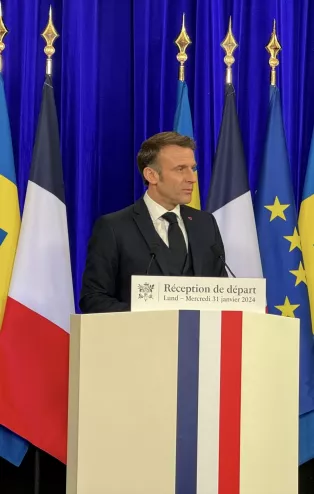 President Macron behind a podium